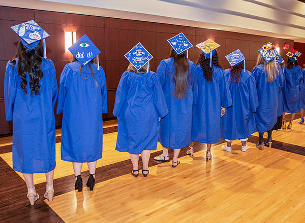 Students showing decorated graduation caps
