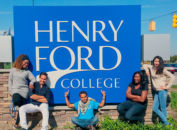 Student Ambassadors sitting in front of HFC sign outside